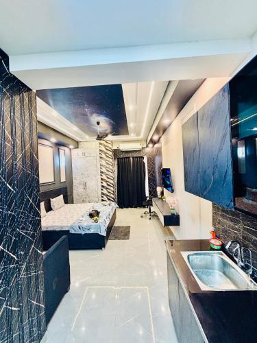 a room with a bed and a sink and a tub at Nior luxury stays in Ghaziabad