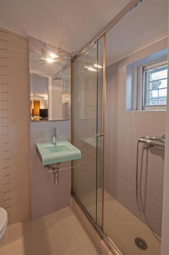a bathroom with a glass shower and a sink at Jenny's Appartment in Faraí