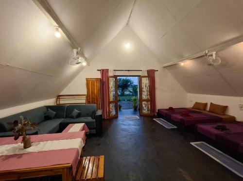 a living room with couches and tables in a tent at Sambu Cabana Panama in Panama