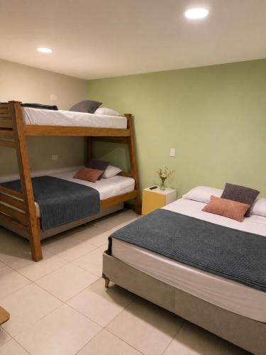two bunk beds in a room withthritisthritisthritisthritisthritisthritisthritisthritisthritis at Casa Tangara Café y Hospedaje in Medellín