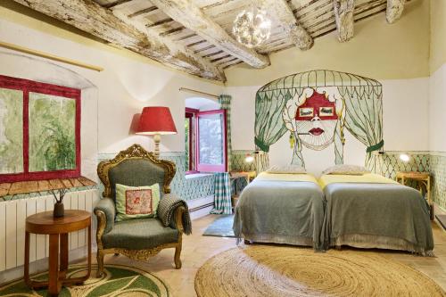 a bedroom with a bed with a mask on the wall at Mas Ferrer Petit by 123ole in Sant Andreu del Terri