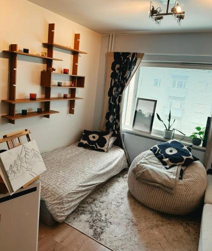 a small room with a bed and a window at Kotikolo in Pori
