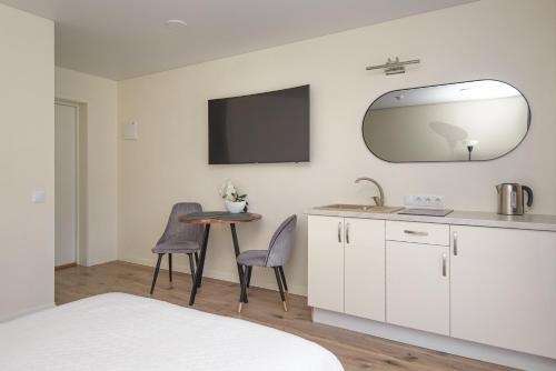a kitchen with a sink and a table with chairs at 2rest in Palanga