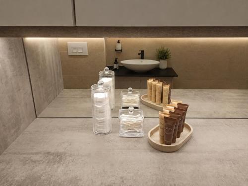 a bathroom with glass bottles on the floor and a sink at Euforia Ma Apartment Sarajevo in Sarajevo