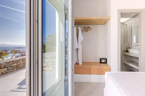 a bedroom with a view of a bathroom at Melora Villas Paros in Aliki
