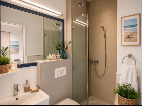 a bathroom with a shower and a toilet and a sink at Villa Tamaris on the beach in Podstrana