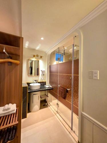 a bathroom with a shower and a sink and a toilet at Tulip Hotel 2 in Da Lat