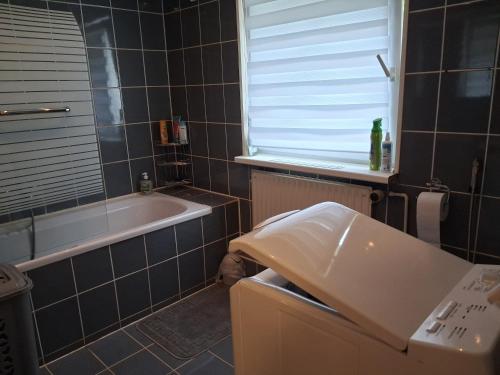 a bathroom with a tub and a sink and a toilet at Talblick & Ruhe in Hirschhorn Langenthal in Hirschhorn
