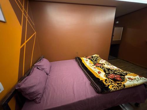 a bedroom with a bed with a blanket on it at Nahor Regency in Guwahati