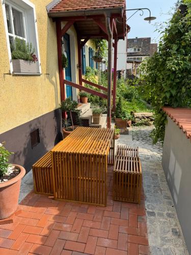 a patio with a wooden bench and a gazebo at CottageCreek in Simmelsdorf