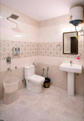 a bathroom with a toilet and a sink at The Woods Boho in Nainital