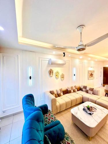 a large living room with a couch and a table at LMY Boutique Hotel Serviced Apartments Blue Area Islamabad in Islamabad