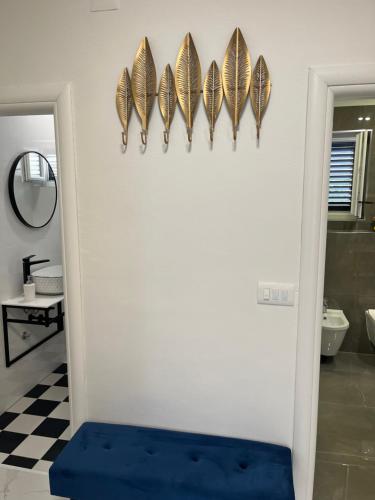 a bathroom with a white wall with butterflies on the wall at Agata in Šibenik