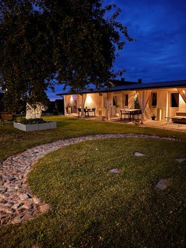 a house with a stone walkway in front of a yard at Domek pod Jabłonią in Barzowice