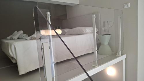a bedroom with a bed with a glass wall at Brizo in Termoli