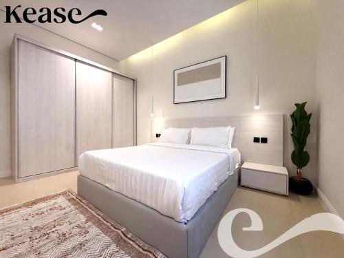 a bedroom with a white bed and a potted plant at Kease Hittin S-18 Latest Development ZA44 in Riyadh