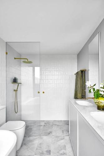 a white bathroom with a shower and a toilet at Destiny home in Curitiba