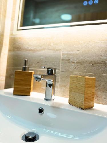 a bathroom sink with a faucet and a mirror at Apartmán Valašský Eden in Horní Bečva