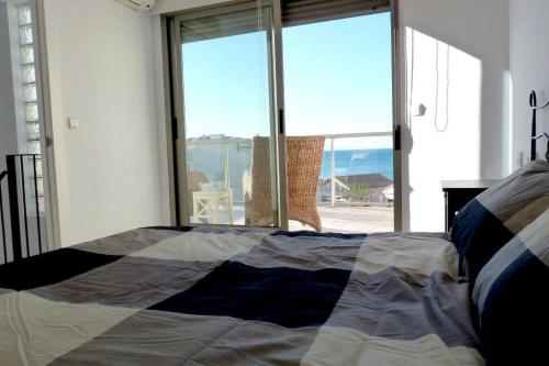 a bedroom with a bed with a view of the ocean at Tierra de Mar 38 in Denia