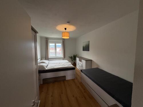 a small bedroom with a bed and a window at Tom s Apartment II in Knittelfeld