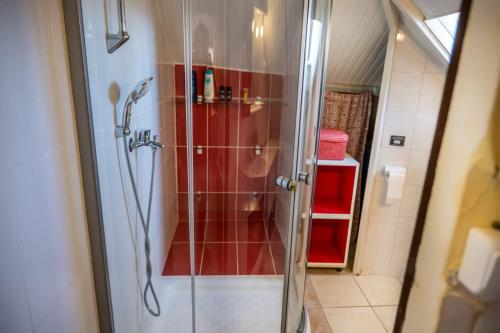 a shower with a glass door in a bathroom at Foothills loft in Keratea