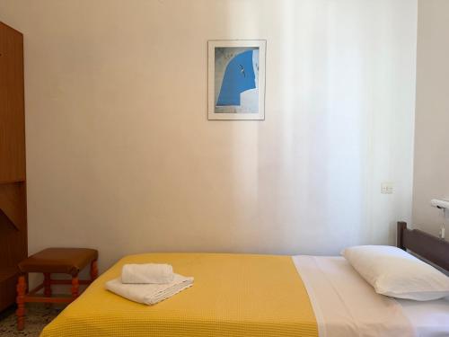 a bedroom with a bed and a picture on the wall at Kythereia Hotel in Agia Pelagia