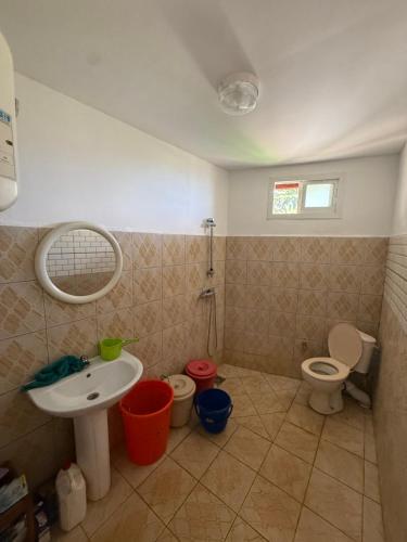 a bathroom with a sink and a toilet at Résidence Maeva in Mtsamboro