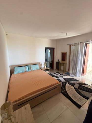 a bedroom with a large bed in a room at Résidence Maeva in Mtsamboro