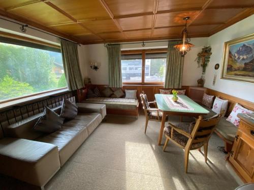 a living room with a couch and a table at Ferienhaus Greti Ehrwald in Ehrwald