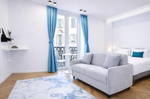 a bedroom with a bed and a couch and a window at B and G San Babila- Luxury in the heart of Milano - Design district in Milan