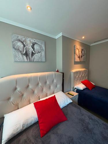 a bedroom with two beds and a red pillow at Departamento 68 river 2 in Guayaquil