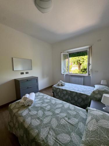 a hotel room with two beds and a window at Casa dolce Casa in Rapallo