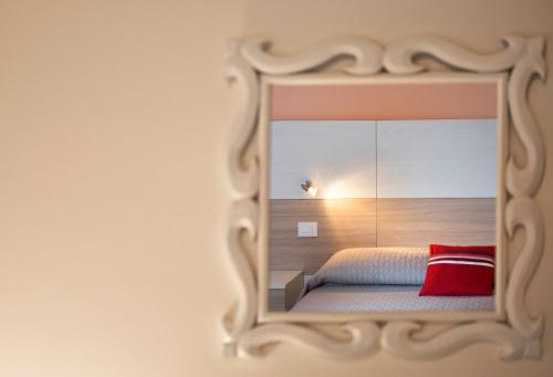 a bedroom with a mirror on the wall at Trapani Home in Trapani