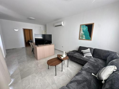 a living room with a couch and a table at Flamingo Vacation Rentals in Paphos