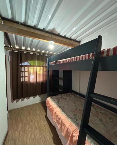 a bedroom with a bunk bed in a room at Chacara desejo do coração dois in Juquitiba