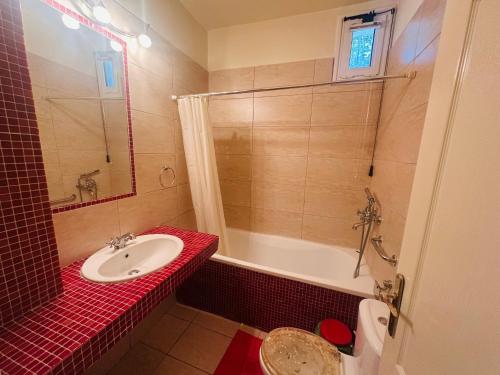 a bathroom with a sink and a shower and a tub at MELIA Holidays & Living in Epanomi