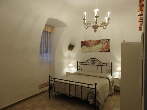 a bedroom with a bed and a chandelier at B&B Goriano Valli in Goriano Valli