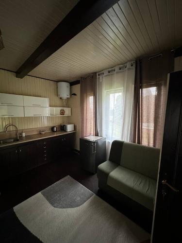 a living room with a couch and a kitchen at Guest House Villa Arkadia in Warsaw