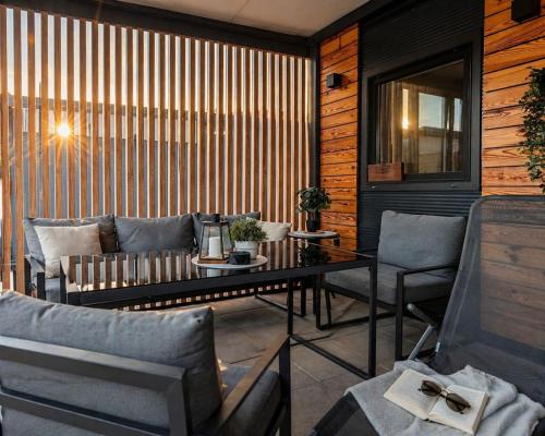 a room with a couch and a table and chairs at Mobile homes Laguna, beach Porat, Drage in Drage