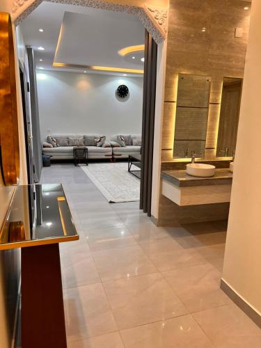 a hallway with a living room with a couch at تلال الفخامة in Hail