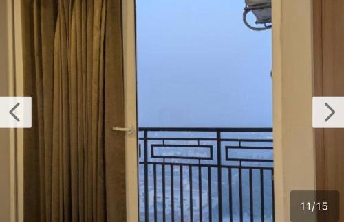 a door to a balcony with a view of the ocean at TOM n JERY STAYS in Greater Noida