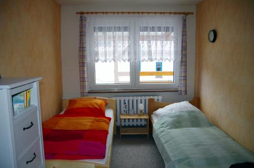 1 Schlafzimmer mit 2 Betten vor einem Fenster in der Unterkunft Ferienwohnung Ferchesar in Stechow