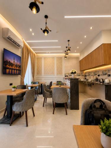 a restaurant with tables and chairs and a kitchen at Havana ViP in Cairo
