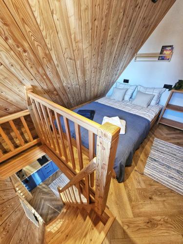 a large bed in a room with a wooden ceiling at Apartament Rysulówka 76 in Kościelisko