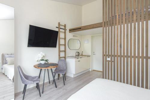 a bedroom with a bed and a table and chairs at 4rest in Palanga