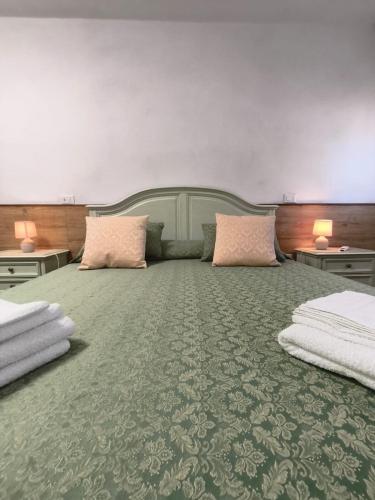 a bedroom with a large bed with two pillows at Il Caminetto in Montecastrilli
