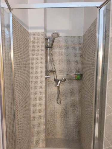 a shower in a bathroom with a glass door at Il Caminetto in Montecastrilli
