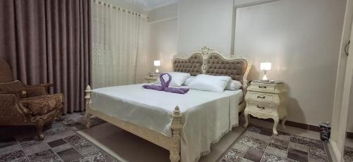 a bedroom with a bed with a purple bow on it at Classic Seaview in Alexandria