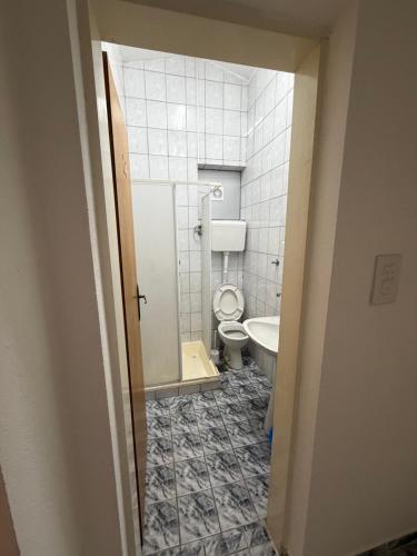 a bathroom with a toilet and a sink at Apartman Sambi 3 in Čanj