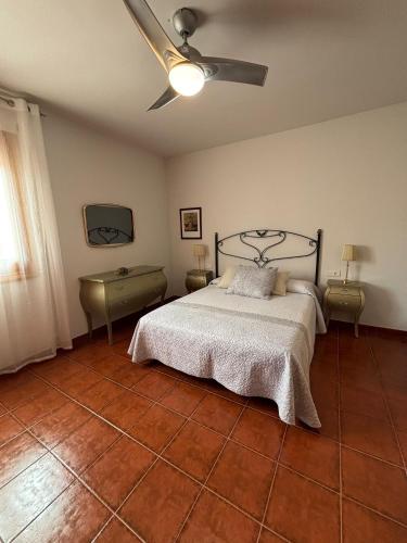 a bedroom with a bed and a ceiling fan at Los Balcones de San Marcos in Galera